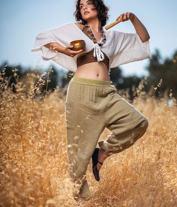 Woman performing a calm yoga pose in a serene environment.